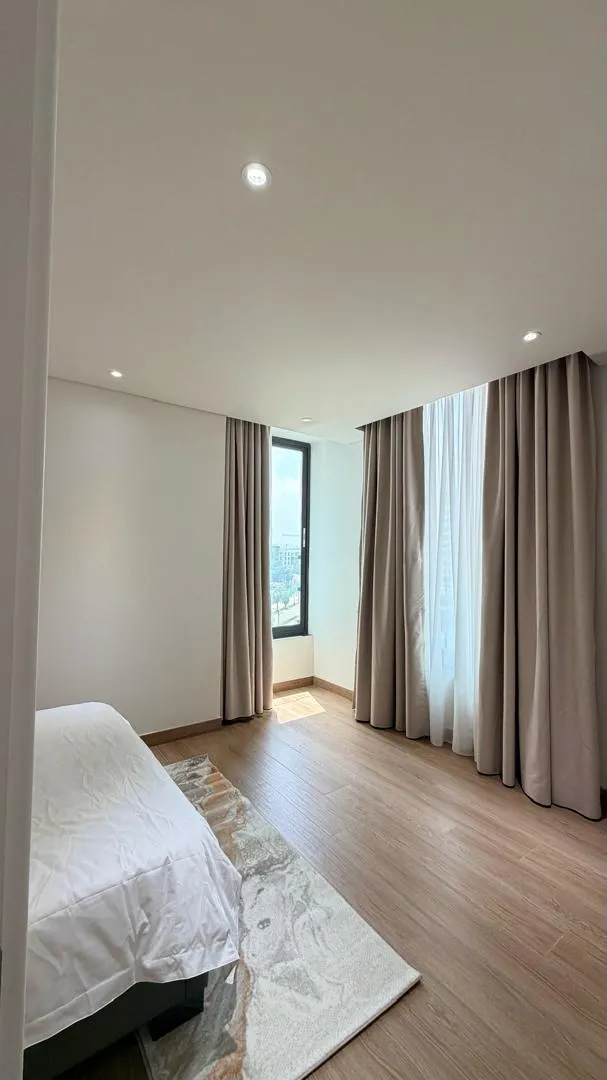 Bedroom beside a full-height window